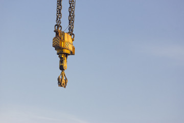 Fototapeta premium Isolated hook crane over a sky background.
