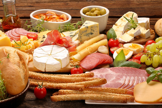 Board of various types of cheese and appetizers set