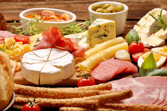 Board of various types of cheese and appetizers set