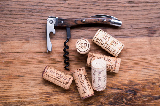 close up flat lay of 2017 vintage new year wine cork with corkscrew on a wooden table