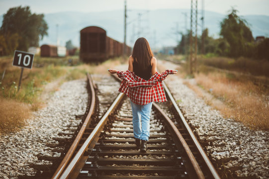 Woman walking along railroad, Banja Luka, Bosnia and Herzegovina