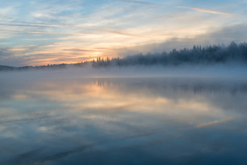 Obraz na płótnie Canvas lake sunrise fog reflection