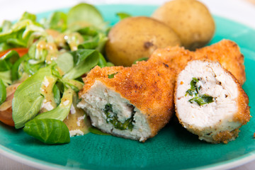 Kiev cutlet with jacket potatoes and salad