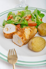 Kiev cutlet with jacket potatoes and salad