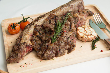 grilled  tomahawk beef steak cut  with fresh rosemary and tomato