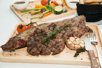  grilled  tomahawk beef steak cut  with fresh rosemary and tomat