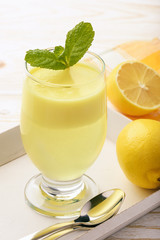 Lemon jelly with mousse on white tray.