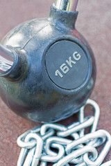 Fototapeta na wymiar Kettlebell With Handle and Chains Background. Fitness Exercise Equipment for Street Workout.
