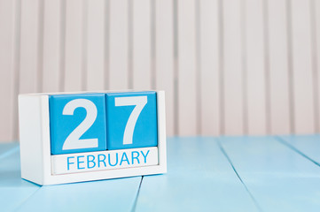 February 27th. Day 27 of month, calendar on wooden background. Winter at work concept. Empty space for text