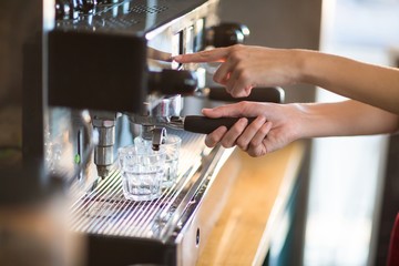 Waitress making cup of coffee