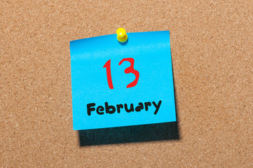 February 13th. Day 13 of month, calendar on cork notice board background. Winter time. Empty space...