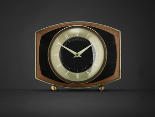 Retro black and gold clock on gray,with shadow