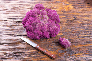 Purple cauliflower on a wooden