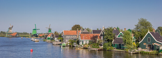Panorama of the Zaan river with historical houses and windmills