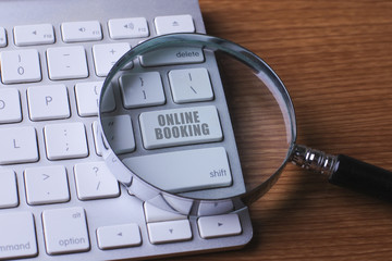 Computer keyboard with ONLINE BOOKING button.