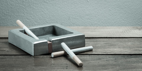 cigarette and ashtray on wood table