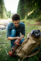 Fototapeta premium Traveler young man of searching direction with a compass in summer outdoor.