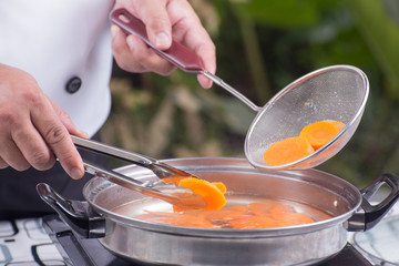 Chef scald carrot with lid