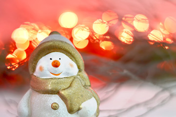 Christmas Snowman and blurred red lights in background