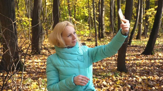 Beautiful Girl Makes Selfie in the Autumn Forest