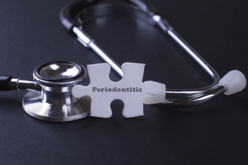 Stethoscope on black with Periodontitis word as medical concept.
