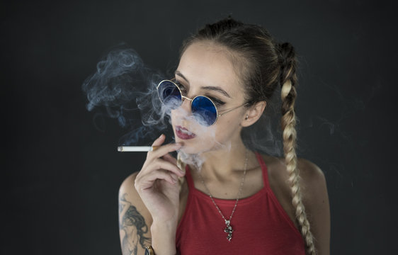 Stylish girl in sunglasses with cigarette