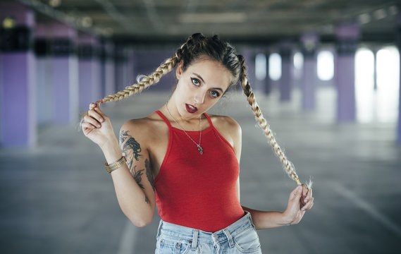 Seductive young girl posing with braids