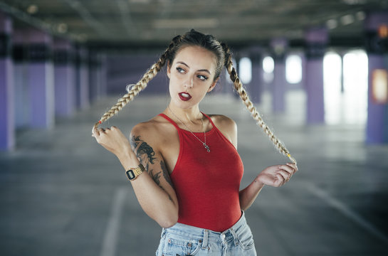 Seductive young girl posing with braids