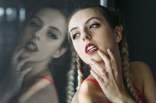 Sensual woman with braid looking at camera