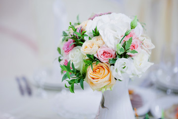 Wedding floristry. Beautiful lush bouquet on the table in restaurant