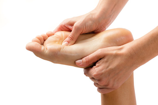 Hands massaging foot isolated.