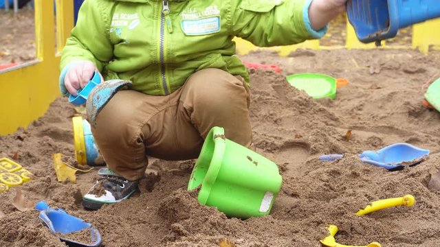 Little Boy Playing In A Sandbox