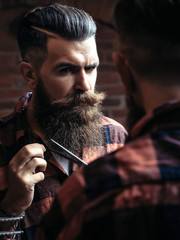 Man hipster cutting beard