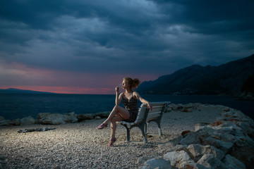 woman with wine on evening beach