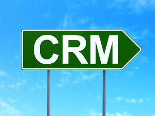 Finance concept: CRM on road sign background