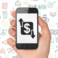 Finance concept: Hand Holding Smartphone with Finance on display