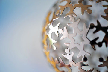 People peace on earth metal ball holiday Christmas ornament close up 