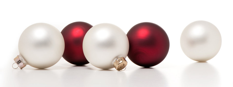 Shiny red and white glass christmas ball ornaments isolated on white background for use alone or as a design element