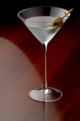 Dirty martini cocktail on wood bar