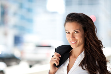 Young Business Woman Outdoors with Coat over Shoulder