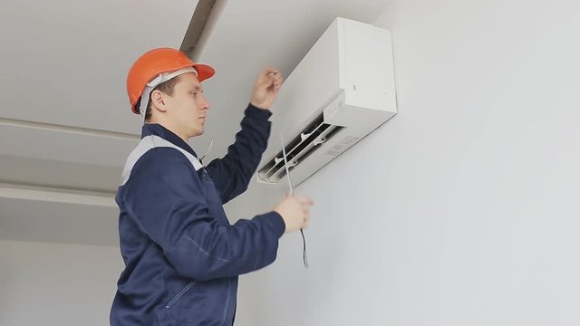 serviceman measures a air conditioning