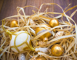 Christmas or New Year background: fur-tree branches, colorful glass balls, decoration and glittering stars on  wood background