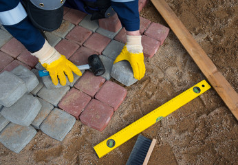 Mason worker making sidewalk pavement