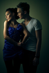 Man leans to posh lady in blue dress