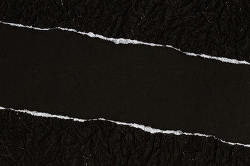 Ripped crumpled black paper with space