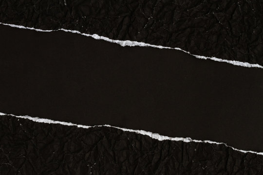 Ripped crumpled black paper with space