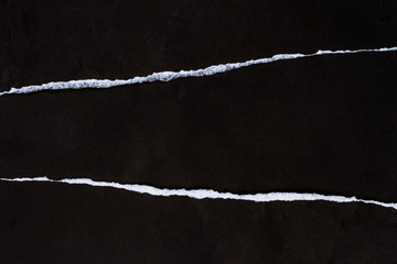 Ripped crumpled black paper with space