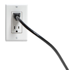 Power cord plugged into electrical outlet on white