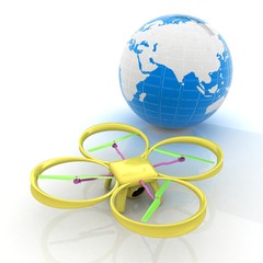 Quadrocopter Drone with Earth Globe and remote controller on a w