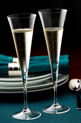 Two Champagne Flutes on blue holdiay table